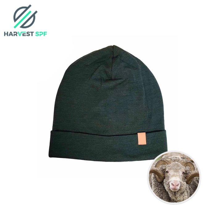 Dark green knitted beanie laid flat